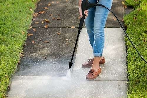 cleaning pavement with an electric pressure washer